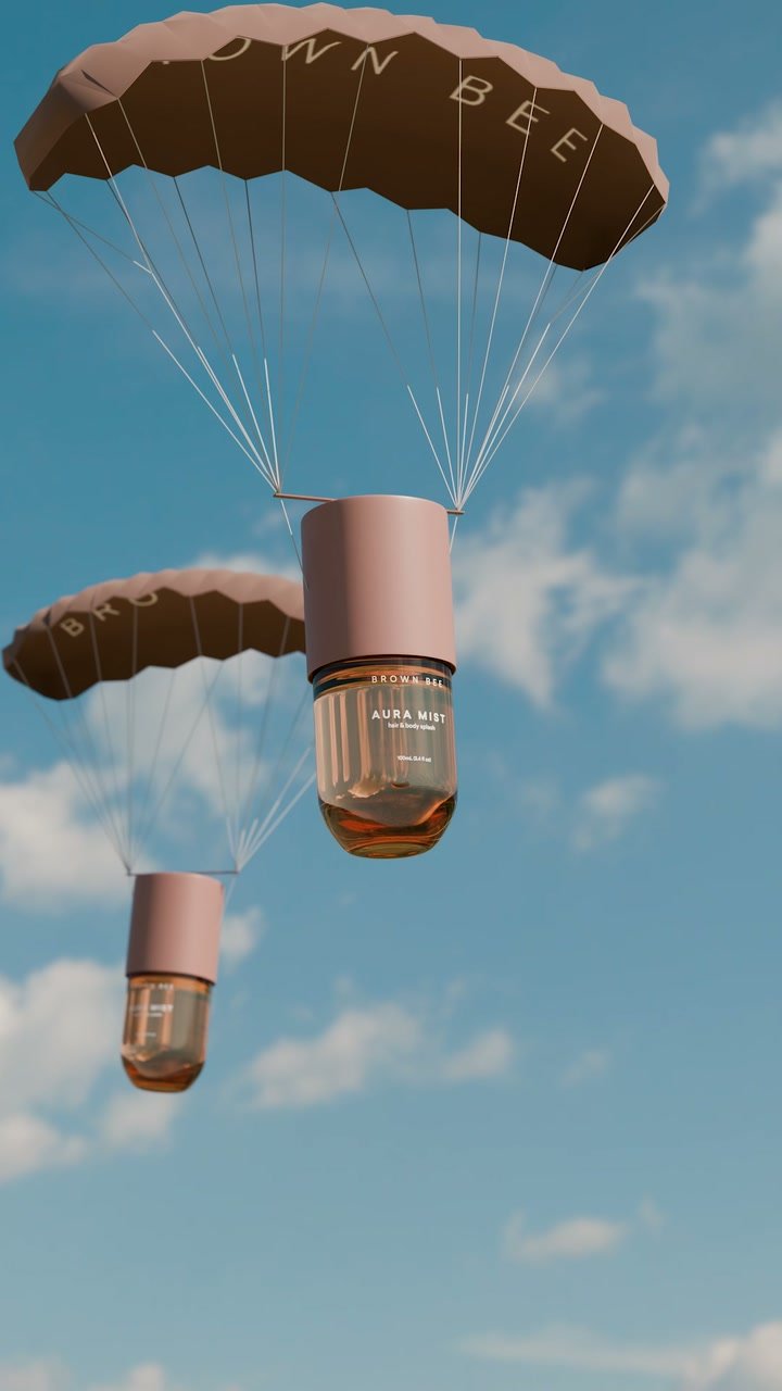 Frascos de Aura Mist de Brown Bee descienden con paracaídas marrones contra un cielo azul